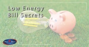A piggy bank is placed beside a stack of coins and a glowing light bulb on green grass, symbolizing energy savings. The text "Low Energy Bill Secrets" highlights valuable money-saving tips, while the Bell Brothers logo in the corner represents their trusted service throughout Northern California. Bell Brothers is known for background-checked technicians, upfront pricing, and their No Surprise Guarantee—delivering honest and dependable solutions to the communities they serve.