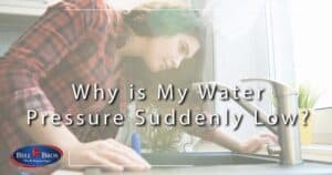 A Bell Brothers technician, who has passed a thorough background check, inspects a kitchen faucet to address low water pressure—one of the many plumbing concerns we solve every day. The graphic features the question “Why is My Water Pressure Suddenly Low?” alongside the trusted Bell Bros. logo. Homeowners across Northern California choose us for our No Surprise Guarantee, honest and upfront pricing, and exceptional reputation for reliable service in our communities.