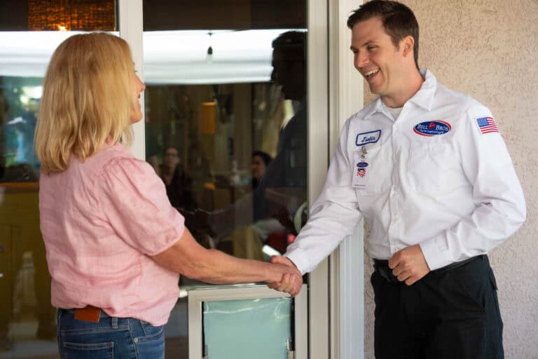 A Bell Brothers technician greets a Sacramento homeowner with a handshake, offering trusted, No Surprise service and upfront pricing.