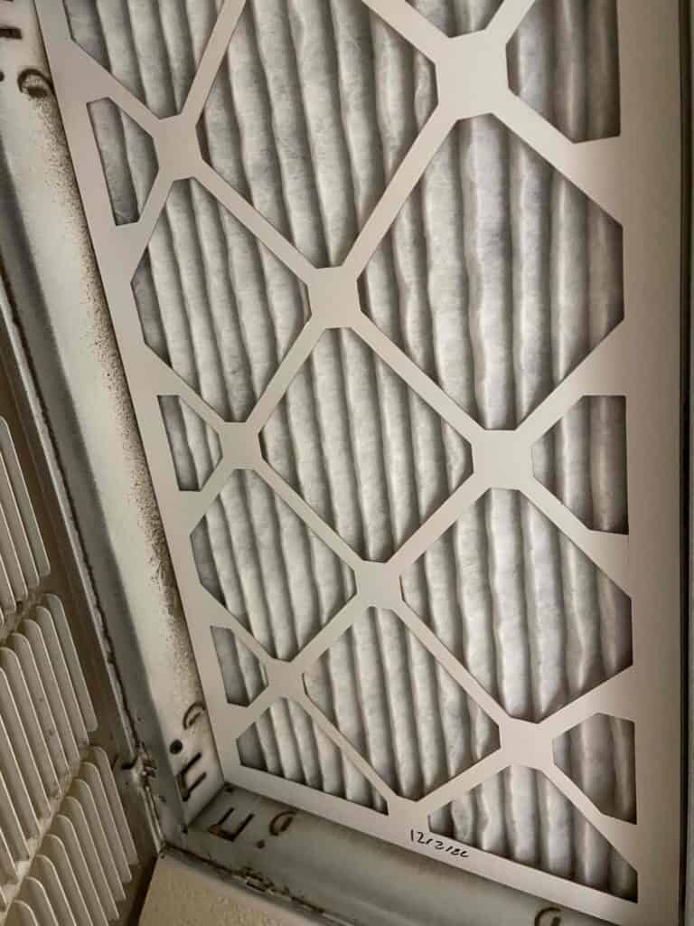 Clean HVAC air filter installed in a ceiling vent, dated—a friendly Bell Brothers reminder for reliable, upfront Furnace Tune-Up service.