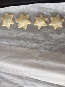 Gwiazdki ułożone na blasze przed pieczeniem pasztecików wigilijnych