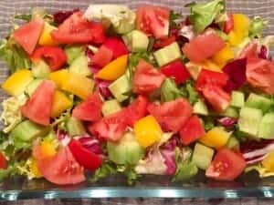 Ogórek i pomidor jako składniki sałatki z mozzarellą