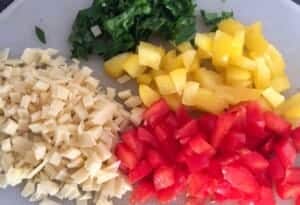 Pokrojona papryka, ser i pietruszka do przepisu na siekane kotleciki drobiowe