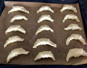 Ułożone rogaliki twarogowe z marmoladą na blaszce