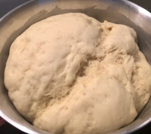 wyrośnięte ciasto drożdżowe na pączusie z konfiturą