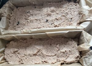 Masa pasztetowa przełożona do foremek przed pieczeniem świątecznego pasztetu