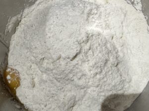 Do wyrabianego ciasta dodajemy śmietanę