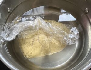 Woreczek z ciastem w garnku z wodą