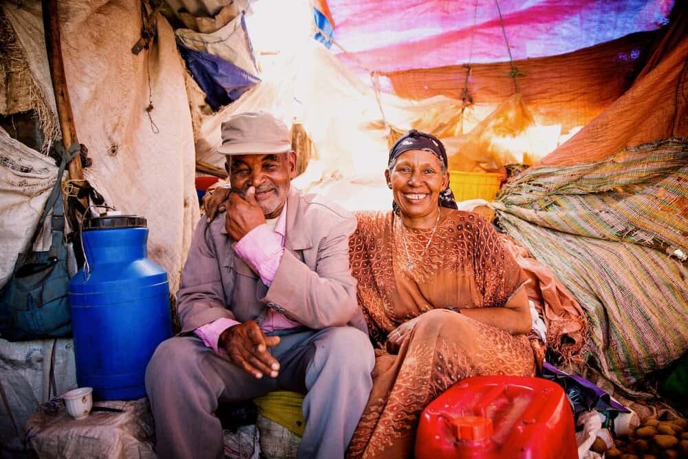 couple sits, smiling at camera