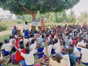 water, sanitation, and hygiene training taking place outside with group of people