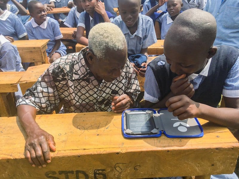 child and adult reading from e-reader