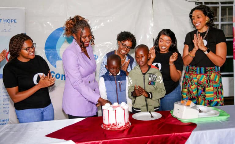 Joyce Maingi celebrating with cake cutting