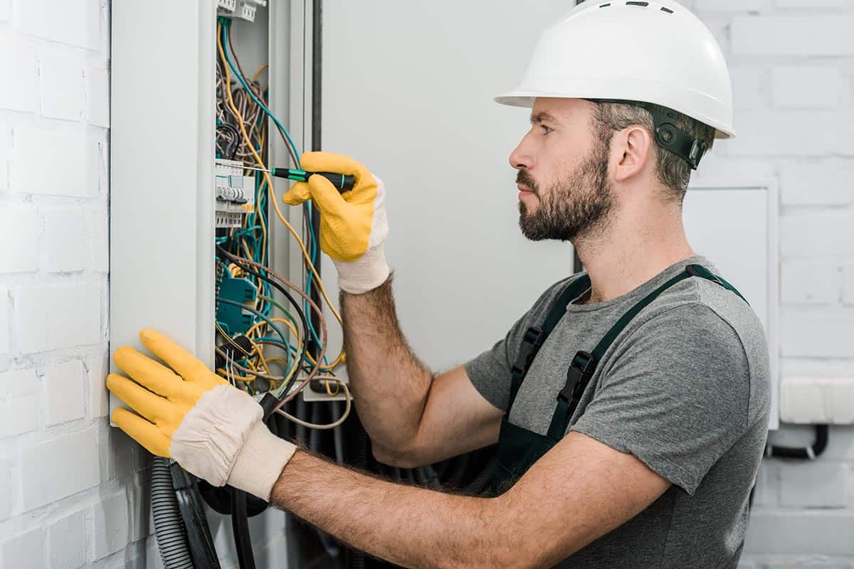 side view of handsome bearded electrician repairin resize.jpg