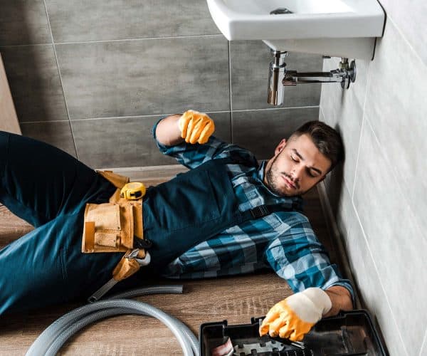 bearded handyman lying on floor near toolbox in ba resize.jpg