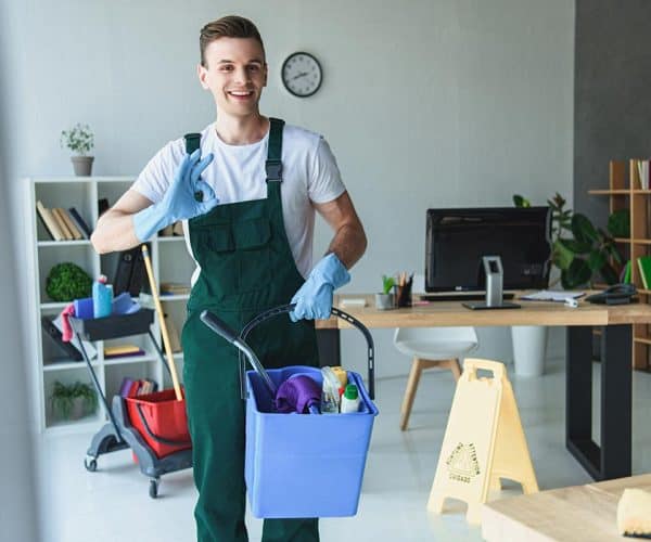 handsome smiling young cleaner holding bucket with resize.jpg