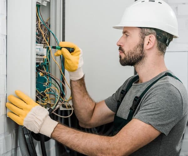 side view of handsome bearded electrician repairin resize.jpg
