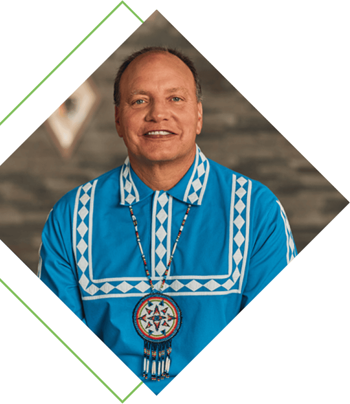 Chief Gary Batton in a traditional blue Choctow shirt and necklace