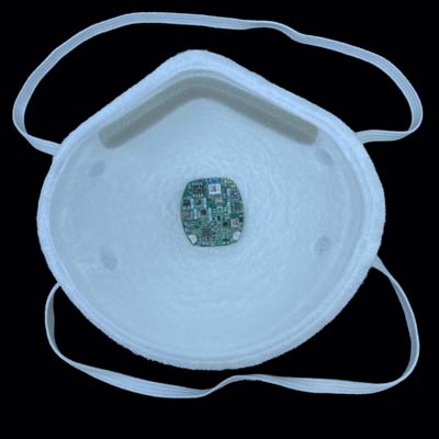 Inside of a respirator with a small battery-powered facebit device attached