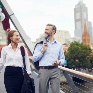 A man and woman walk home from work