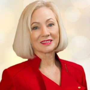 An older woman with a short blond bob smiling