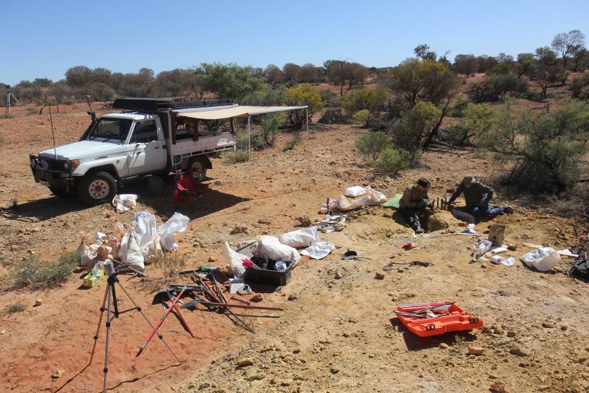 Field trip in the desert with car and camping equipment