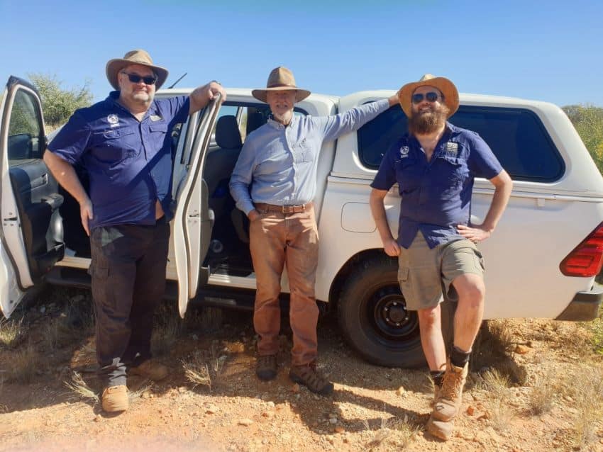 Three people standing in front of ute smiling