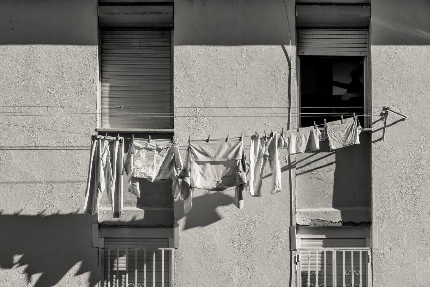 White clothes hanging on clothesline in city