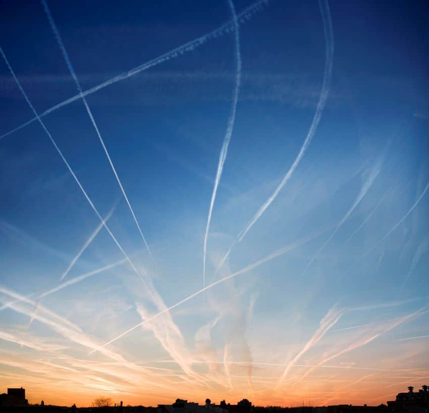 Flight contrails over sunset