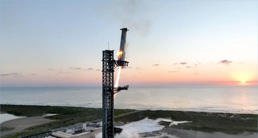 Rocket booster firing engines descending towards metal tower