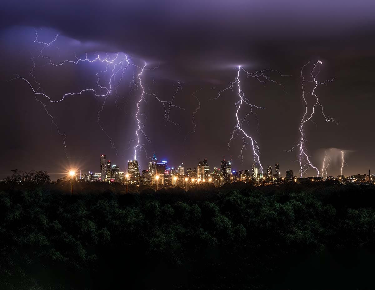 Lightning flashes across a night sky.