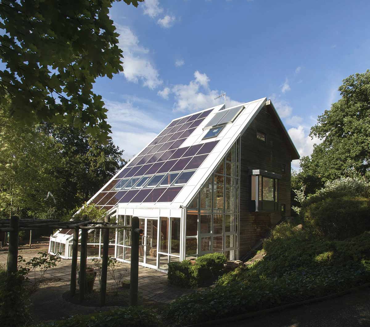 A small house with solar panels covering the roof.