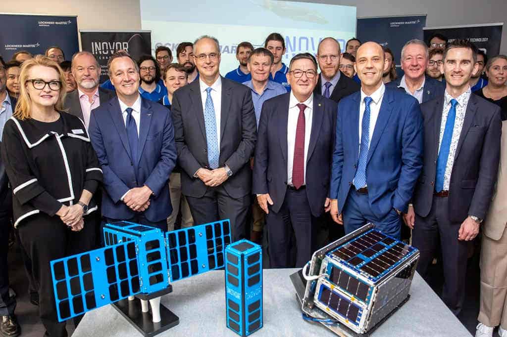 Group of people with small satellite models