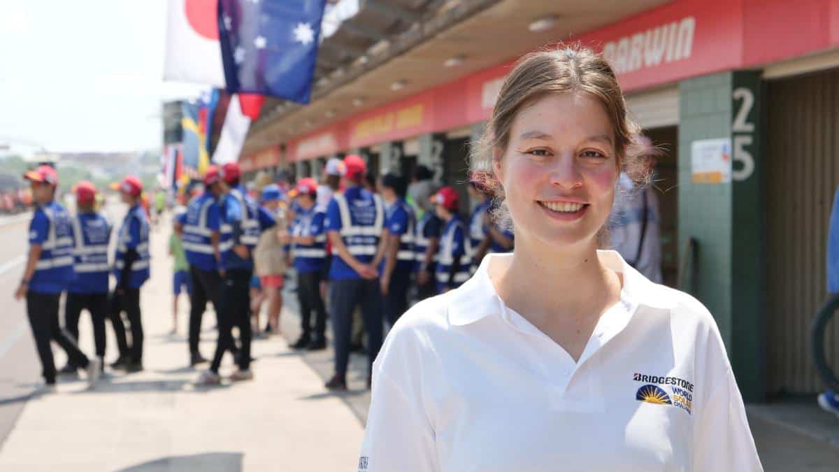 A woman standing outside a motor circuit