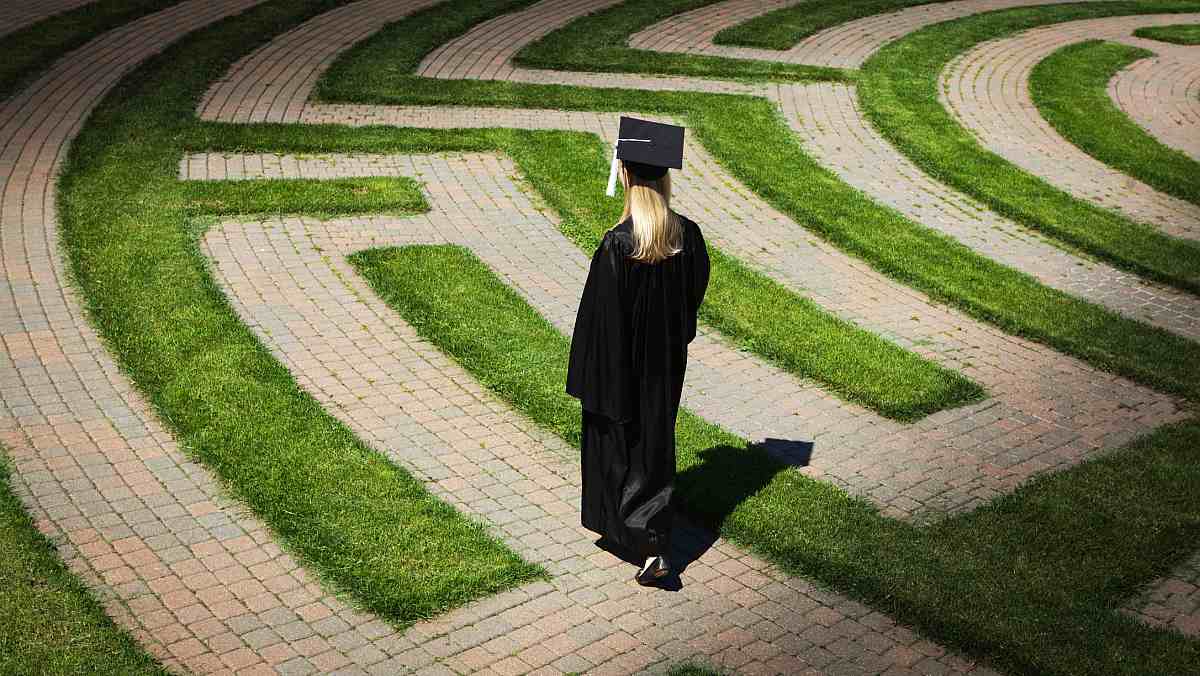 A graduating student making their way through a maze.