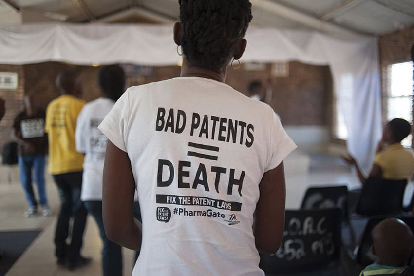 A woman wears a t-shirt with the slogan 'bad patents equals death'.