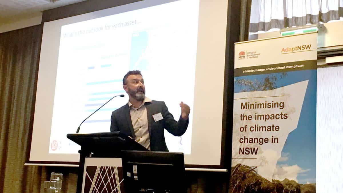 A man presents to an audience at a public gathering.