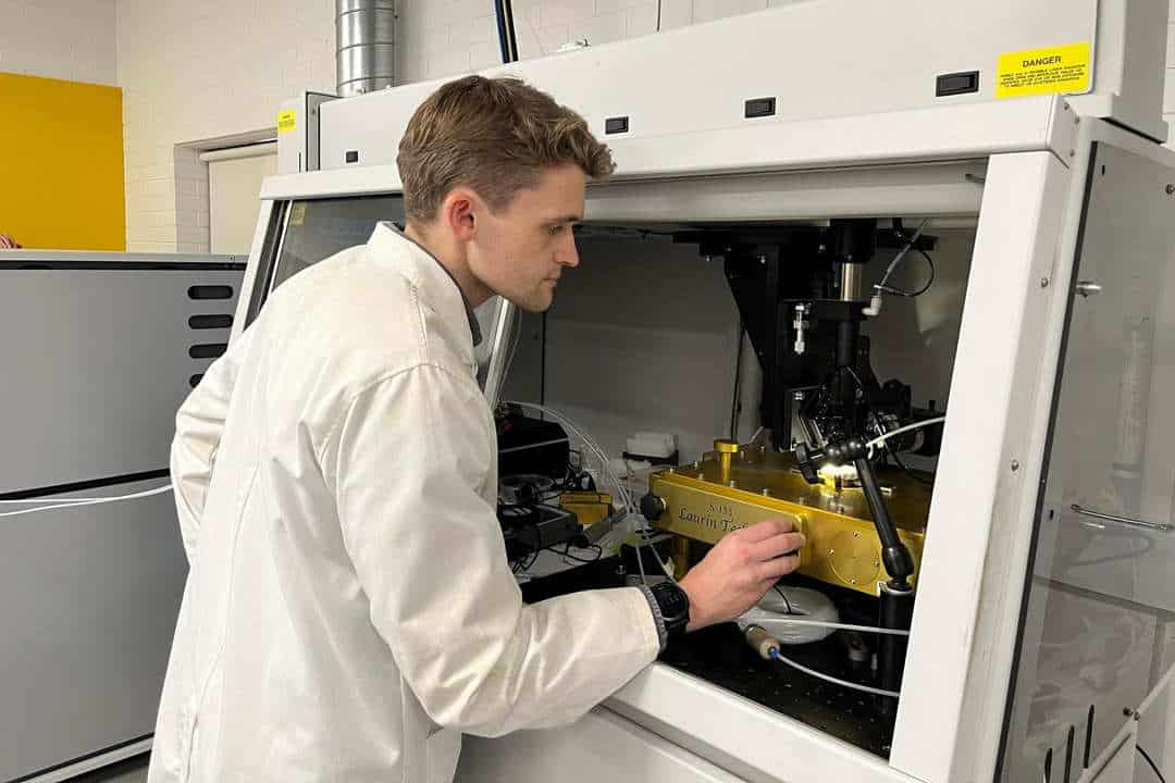 Researcher in lab coat studying samples