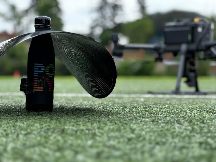 A water bottle with a disc attached to the neck