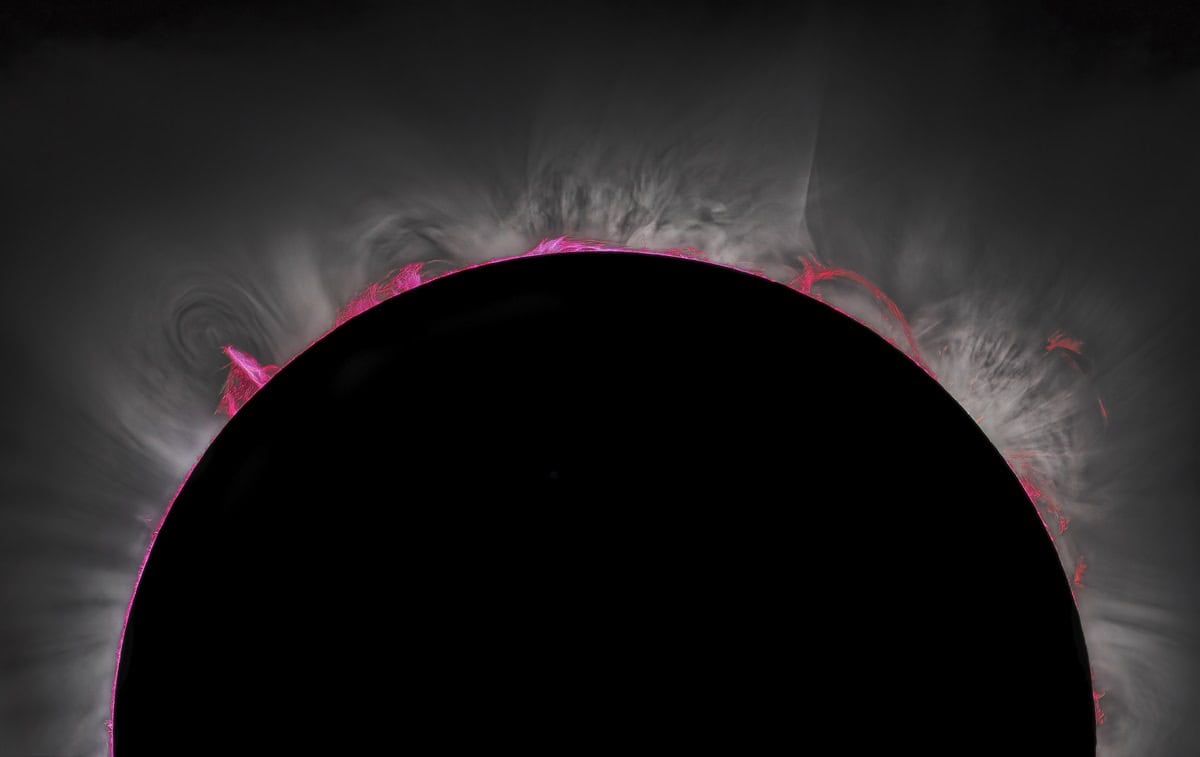 Solar corona behind moon during eclipse