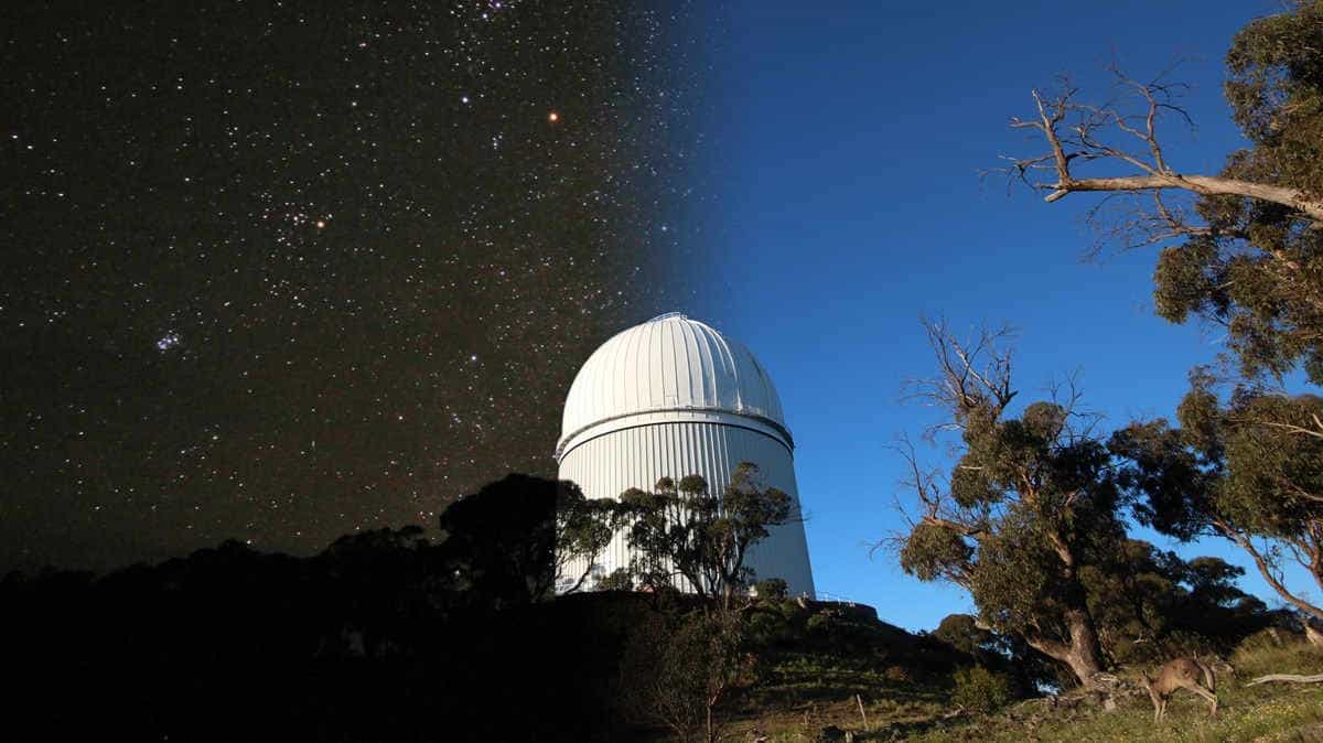 An image of a telescope dome, with half the background in daylight and half in night