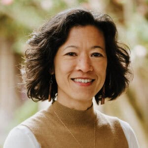 Woman in brown turtleneck jumper.