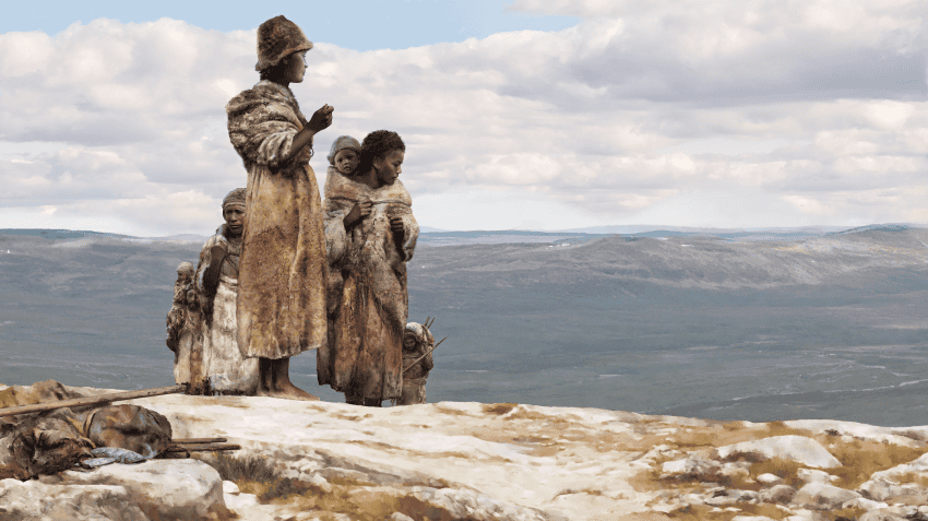 An illustration of a small group of ancient humans with dark skin and wearing furs as they climb a hill overlooking green grasslands.