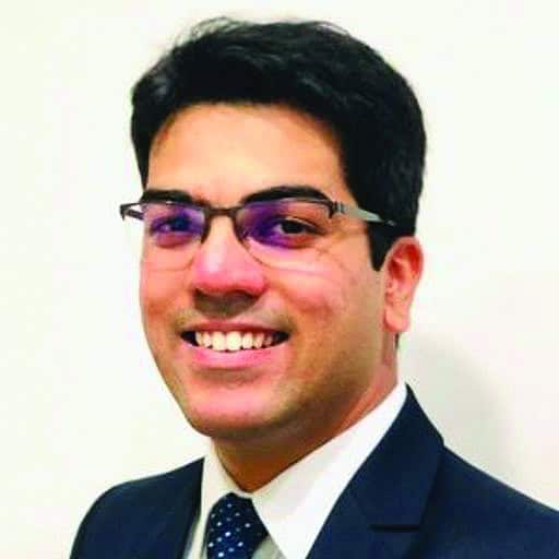 Man wearing glasses tie and suit.