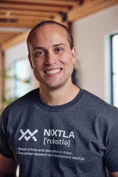 Man smiling wearing nixtla t-shirt.