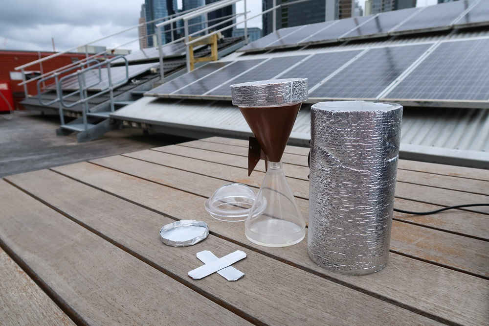 Cup funnel beaker on table on city rooftop with solar panels in background