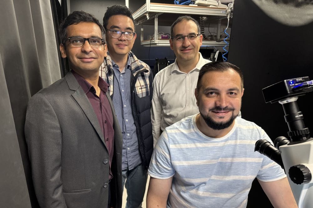 Group of researchers in lab with microscope