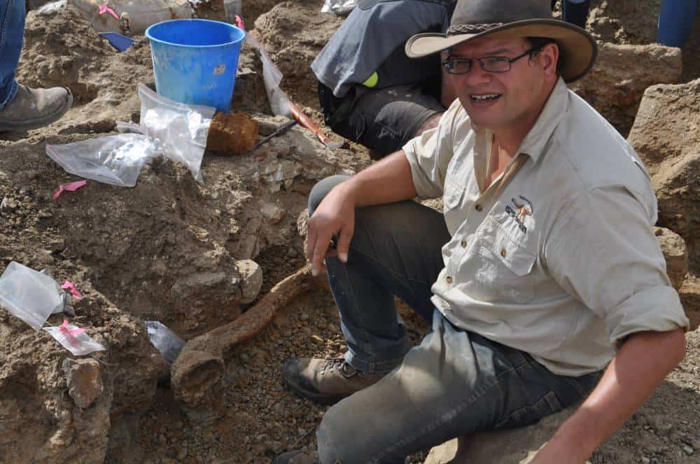 Palaeontologist digging fossils in dirt