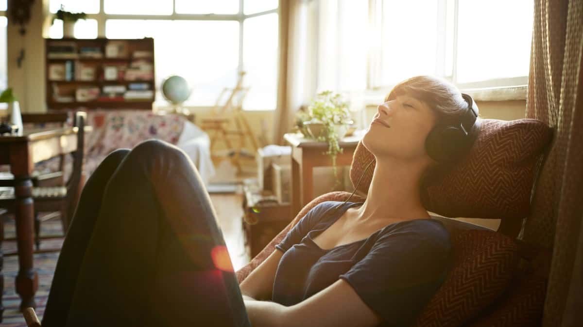 Young woman relaxing with headphones at home
