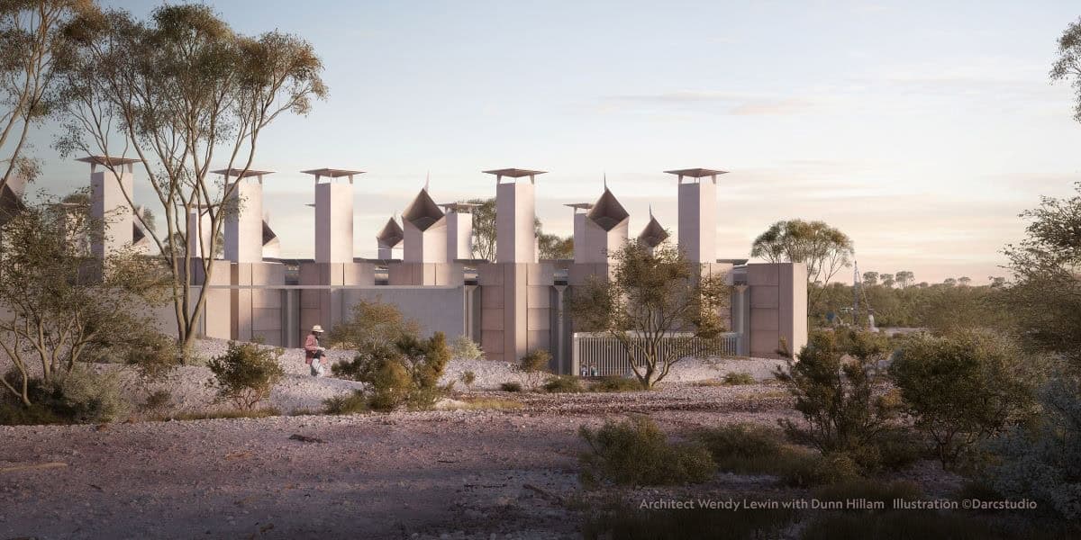 Modern building with multiple chimneys, in flat rocky landscape