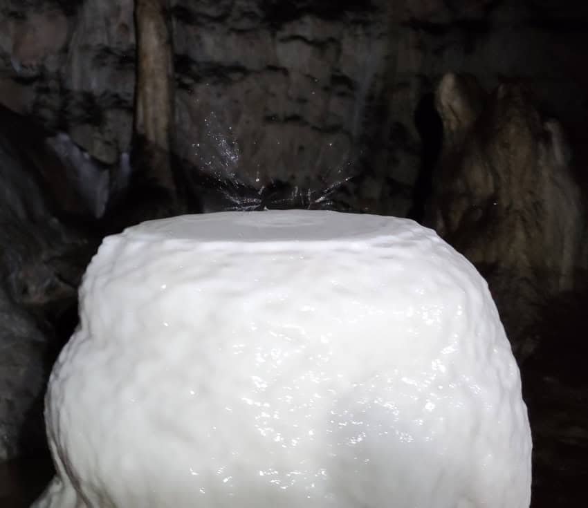 A flat-topped stalagmite of white stone